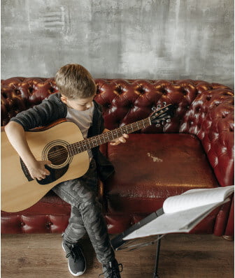 Child Learning Guitar