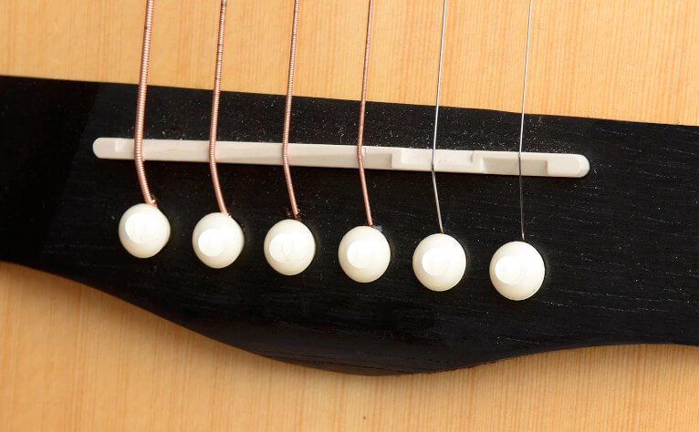 Close up of an Acoustic guitar saddle