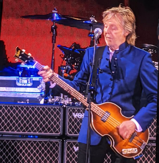 Paul McCartney playing the bass guitar.